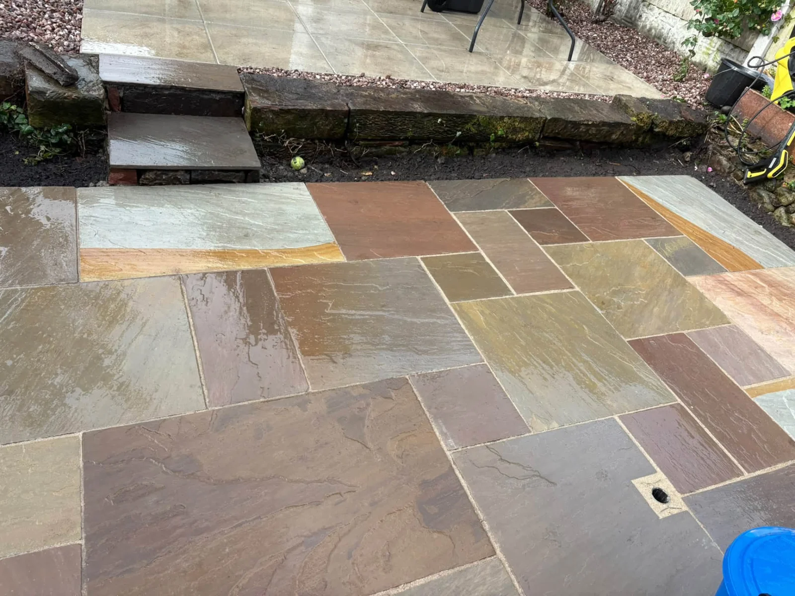 Multicoloured natural sandstone patio with neatly finished joints