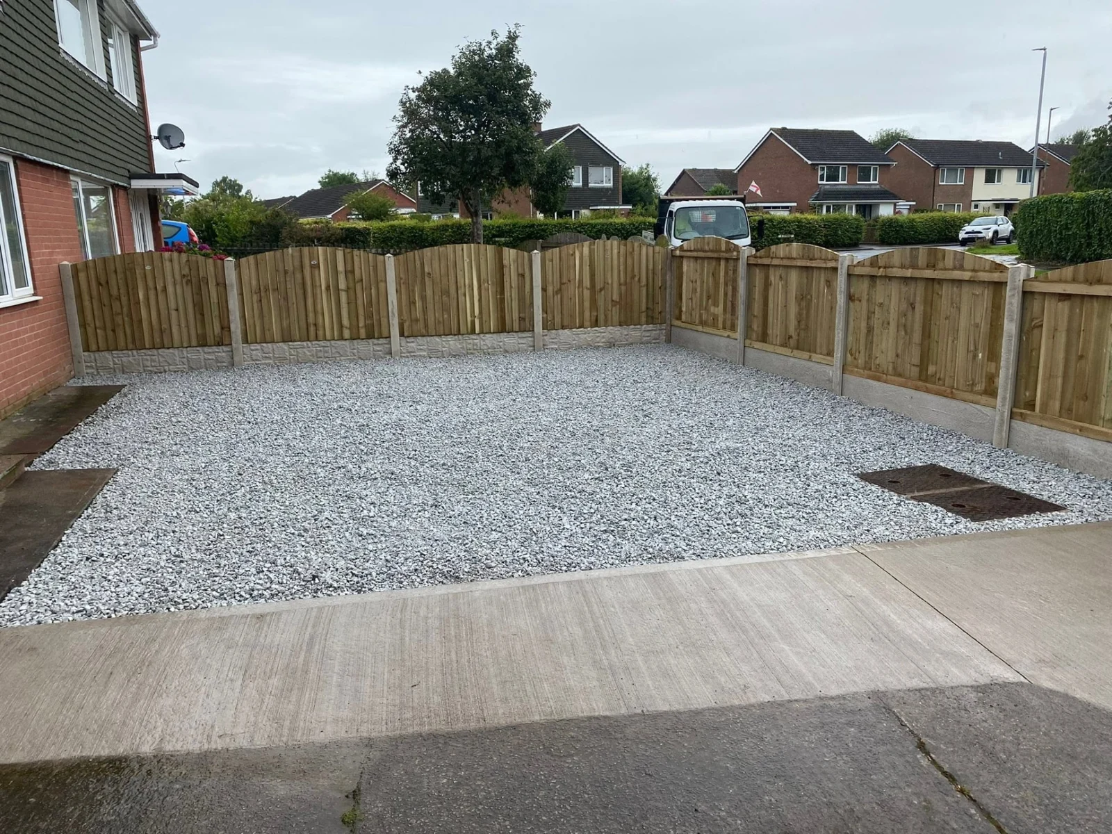 Low-maintenance gravel garden with new timber fencing and a garden gate